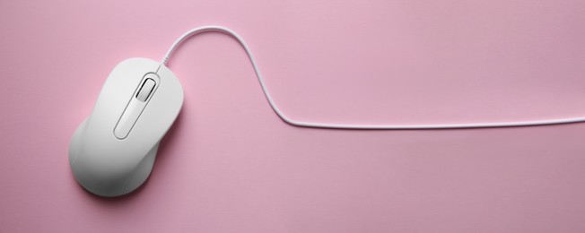 Computer mouse on pink background, top view. Banner design with space for text