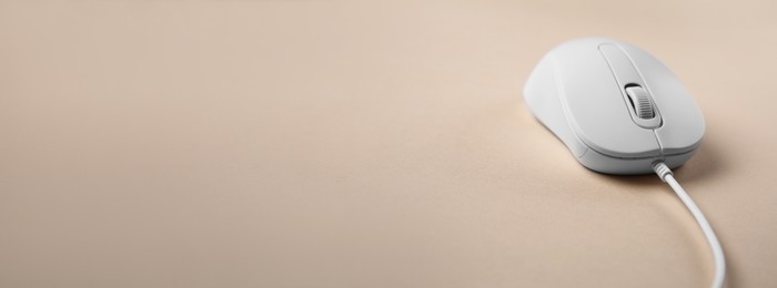 Computer mouse on beige background. Banner design with space for text