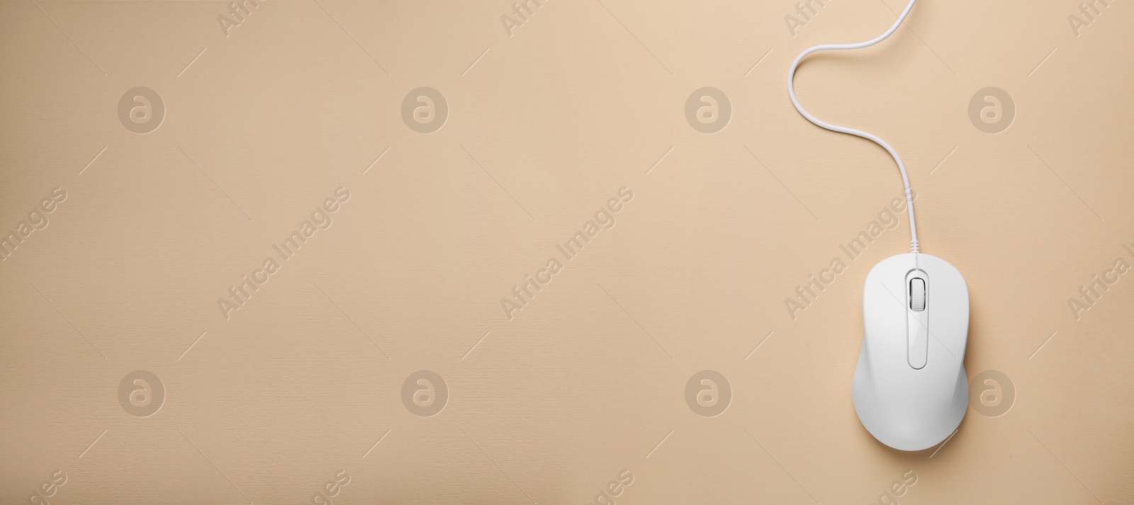 Image of Computer mouse on beige background, top view. Banner design with space for text