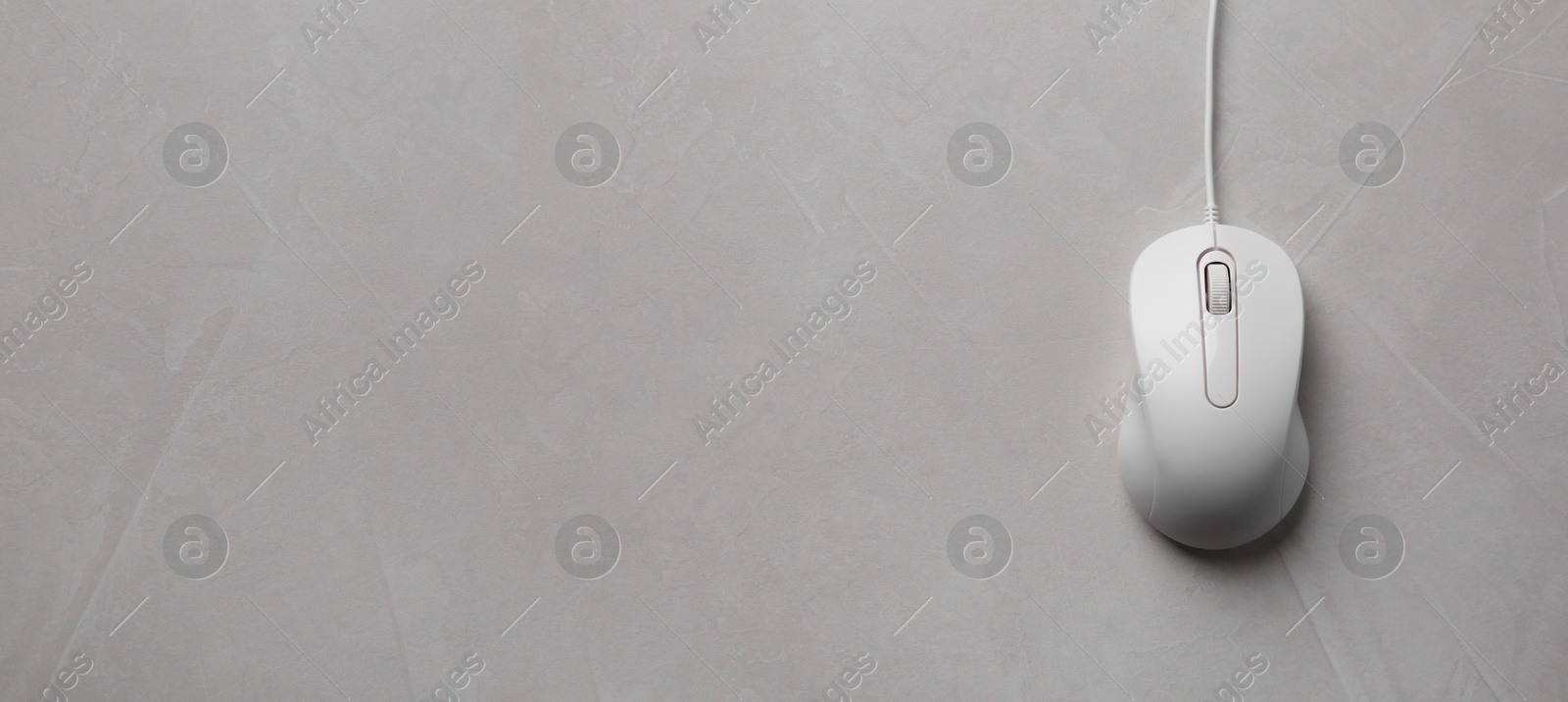 Image of Computer mouse on grey table, top view. Banner design with space for text