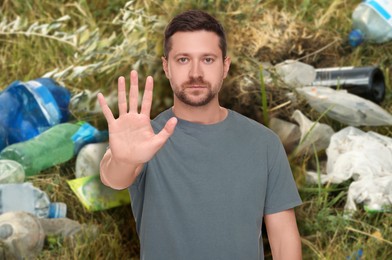 Image of Environmental pollution. Man showing stop gesture among garbage on green grass