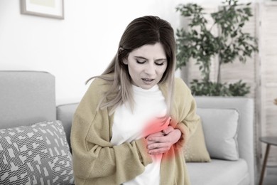 Image of Heart attack. Woman suffering from pain and pressing hands to chest indoors