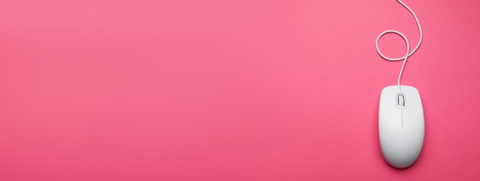 Computer mouse on pink background, top view. Banner design with space for text