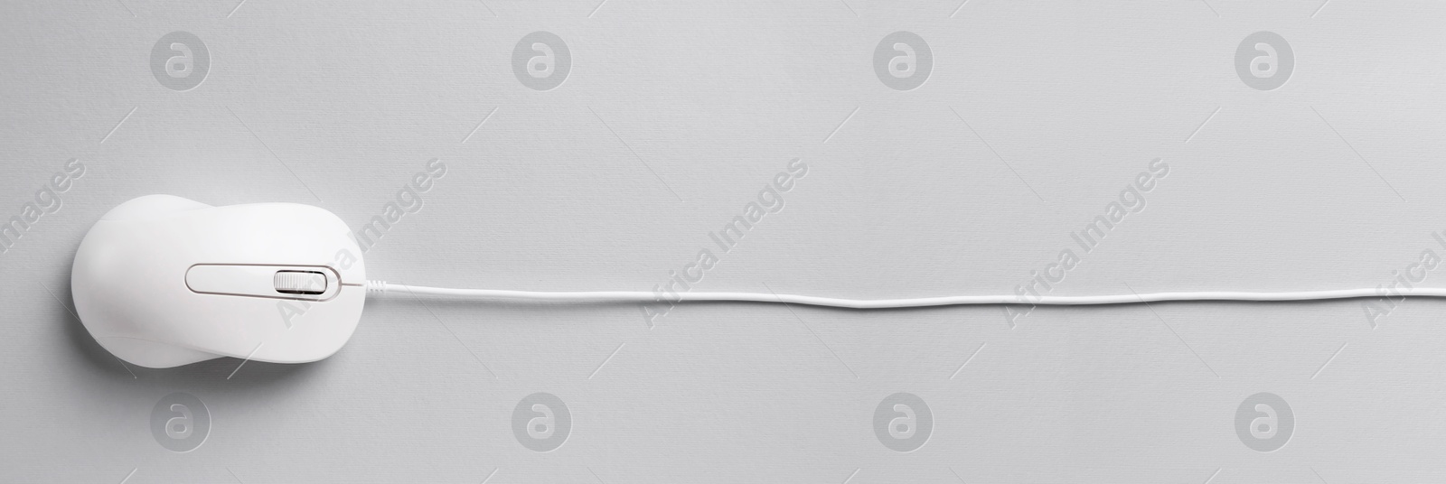 Image of Computer mouse on light grey background, top view. Banner design with space for text