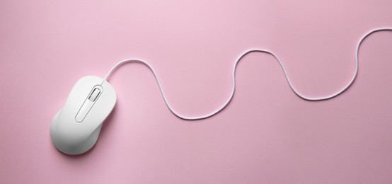 Computer mouse on pink background, top view. Banner design with space for text