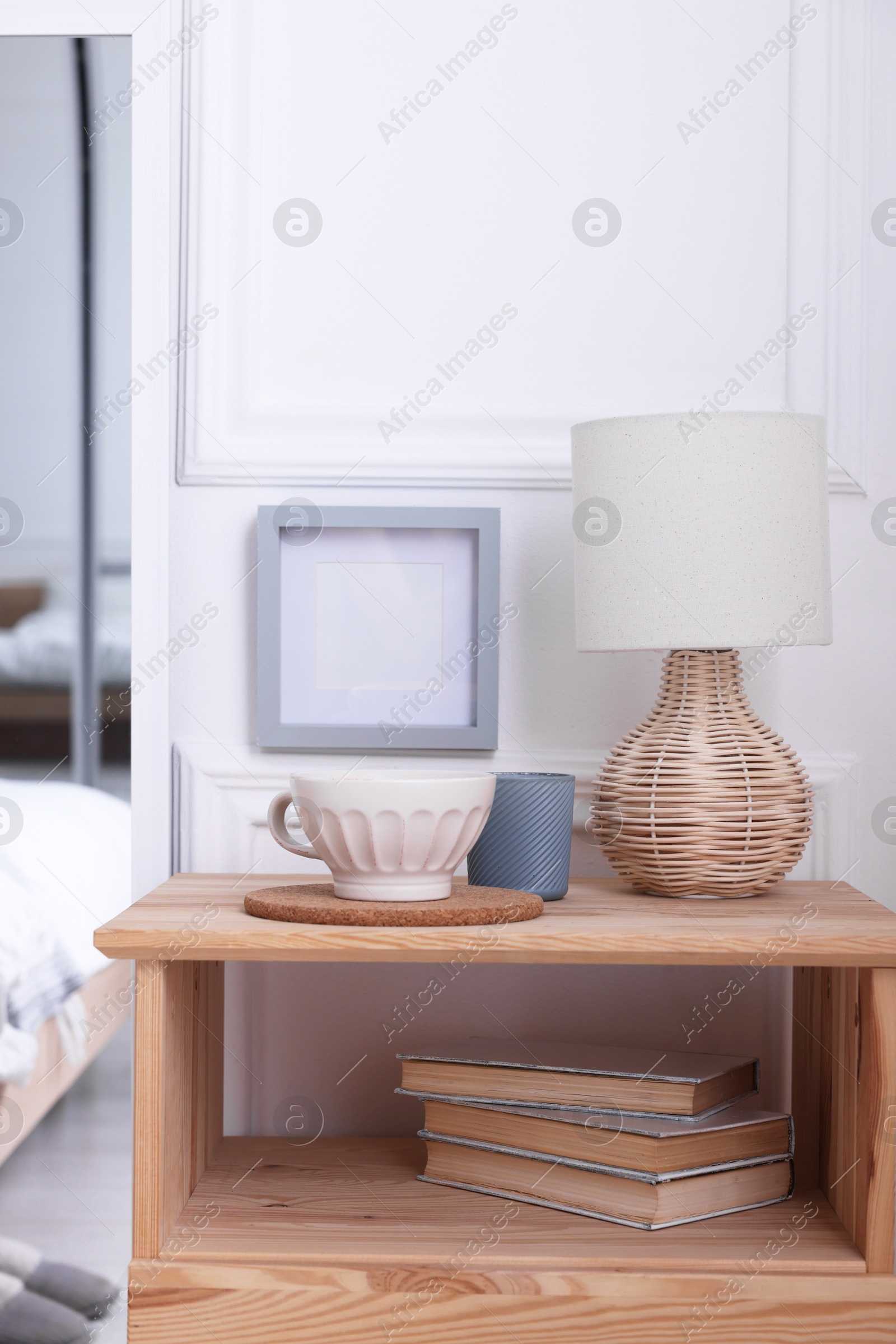 Photo of Stylish living room interior with bed, bedside table and lamp