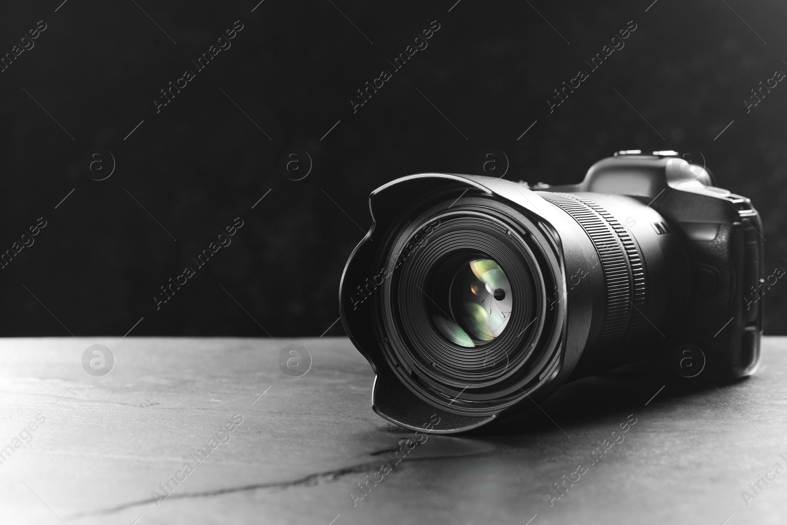 Photo of Modern photo camera on grey table, space for text