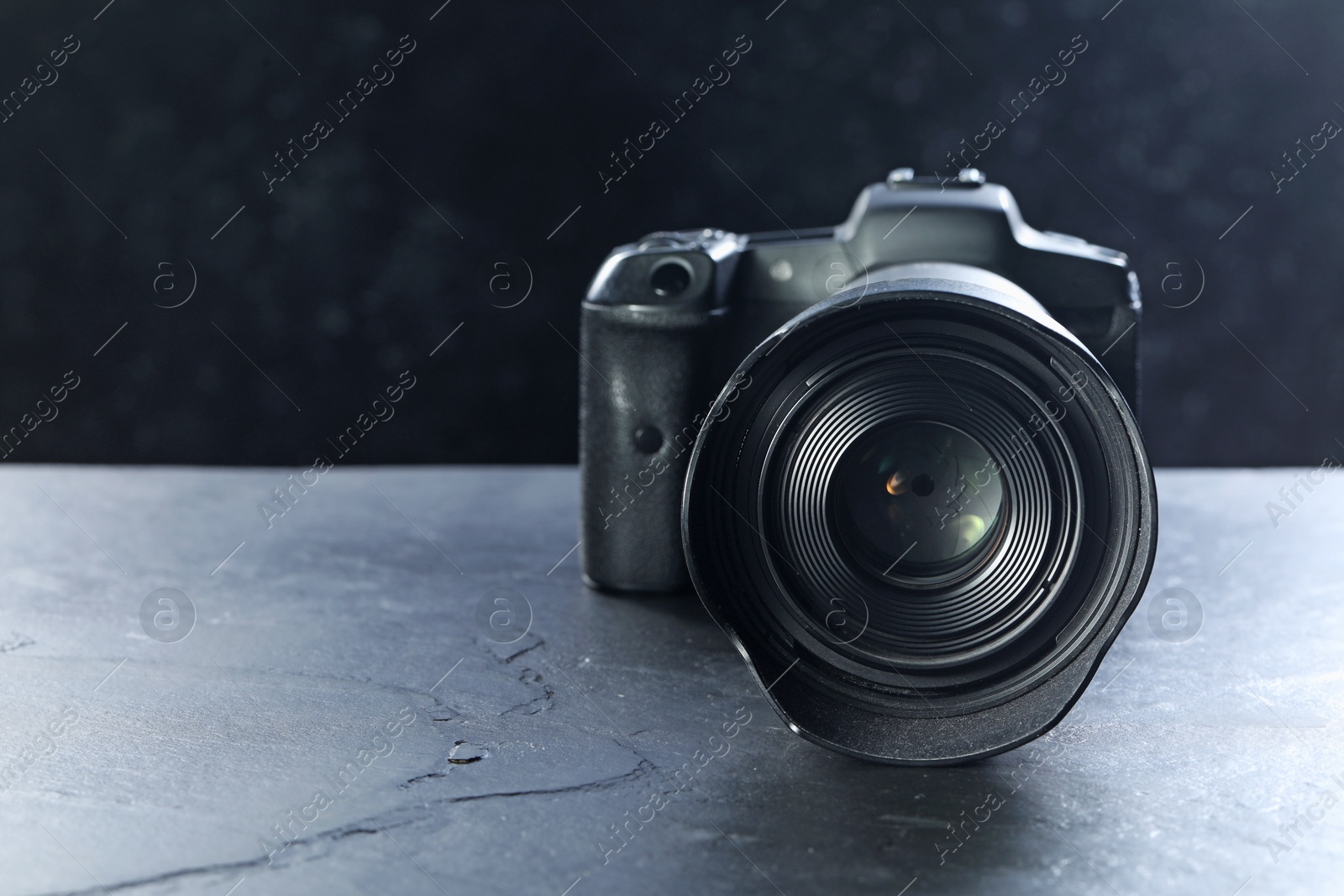 Photo of Modern photo camera on grey table, space for text