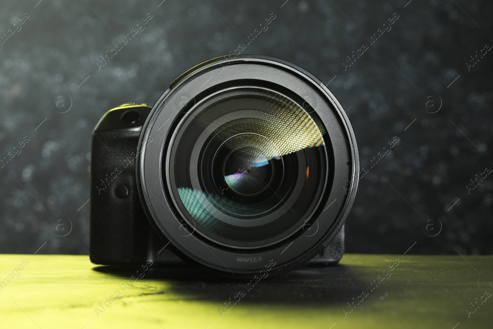 Photo of Modern photo camera on black table. Photographer's equipment