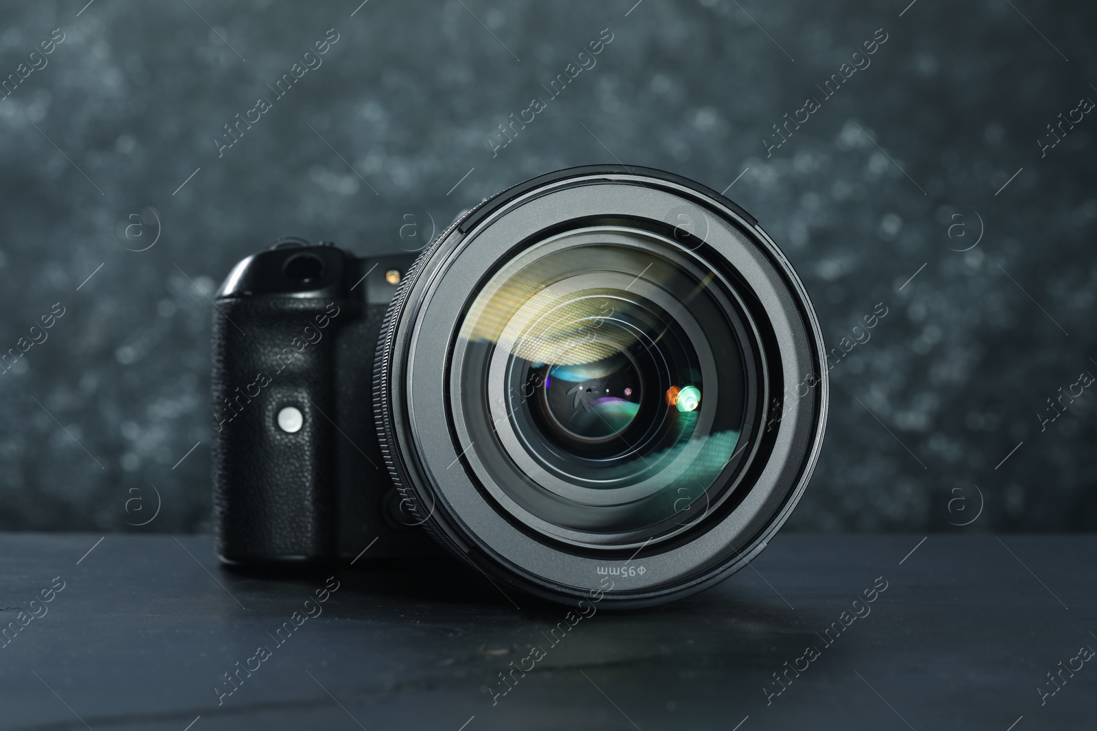 Photo of Modern photo camera on black table. Photographer's equipment