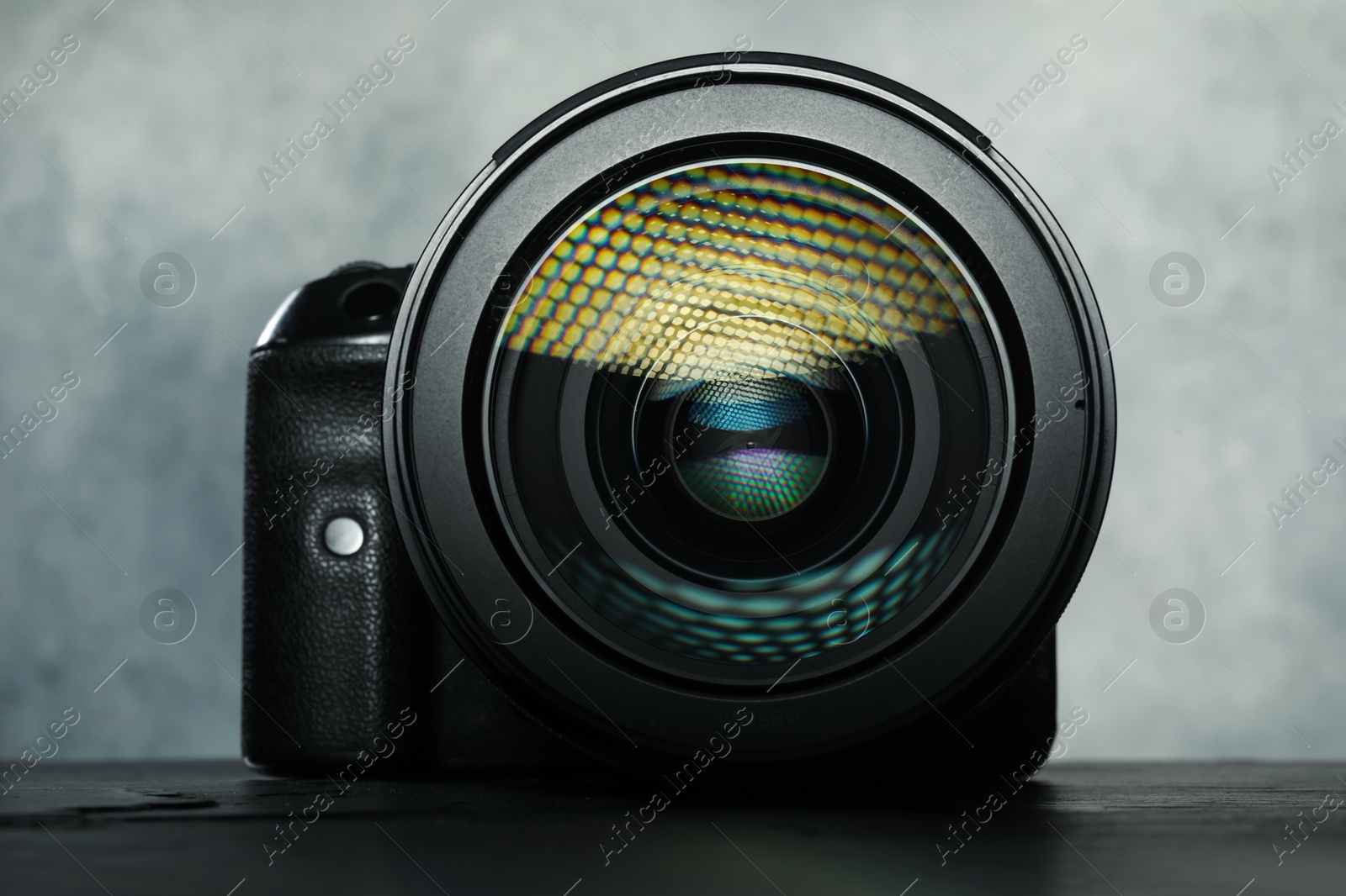 Photo of Modern photo camera on black table. Photographer's equipment