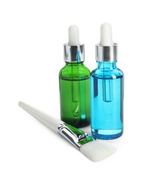 Bottles of chemical peel and brush isolated on white. Peeling procedure