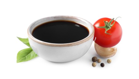 Photo of Delicious balsamic vinegar, basil , tomato, garlic and peppercorns isolated on white