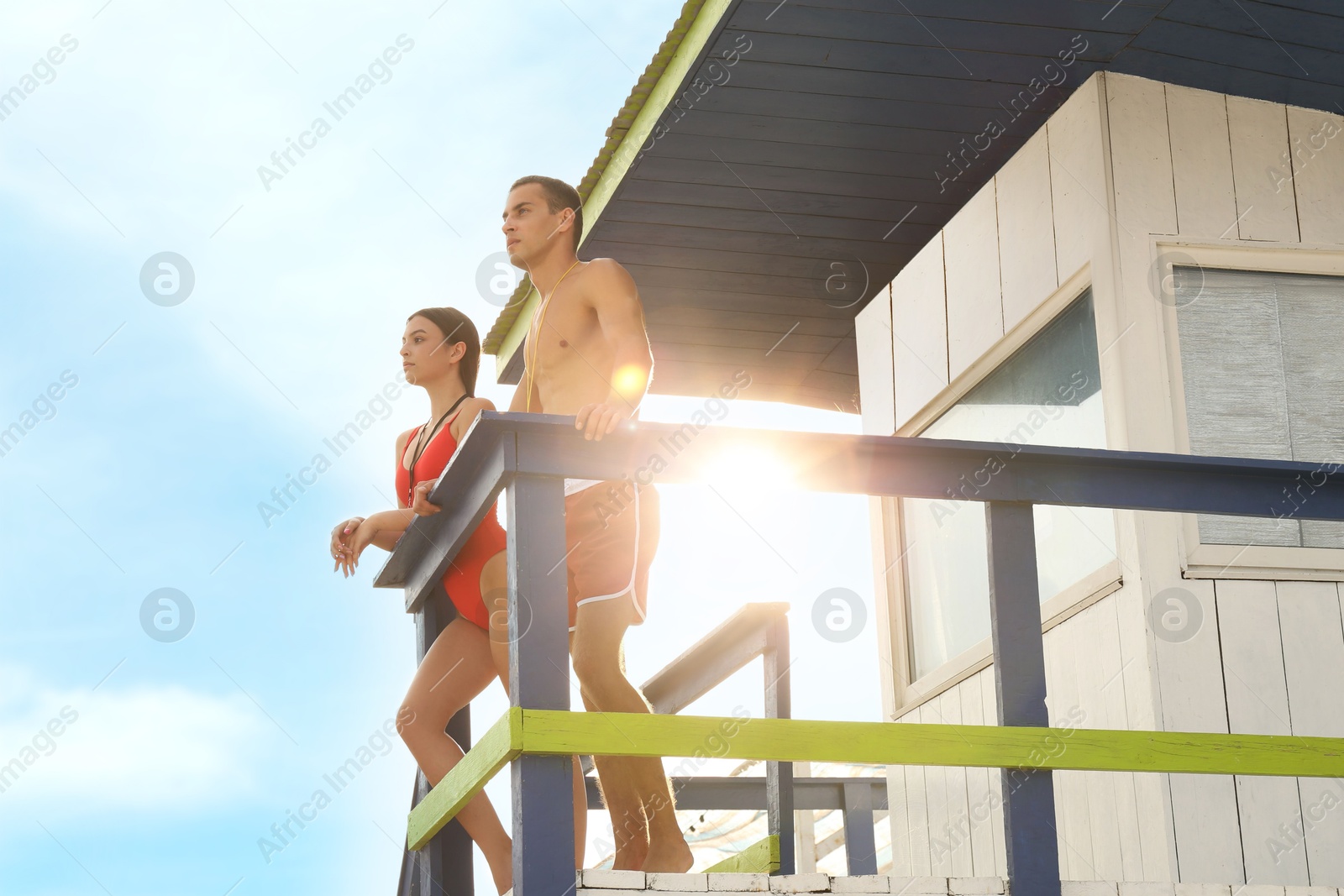 Photo of Professional lifeguards with whistles on watch tower