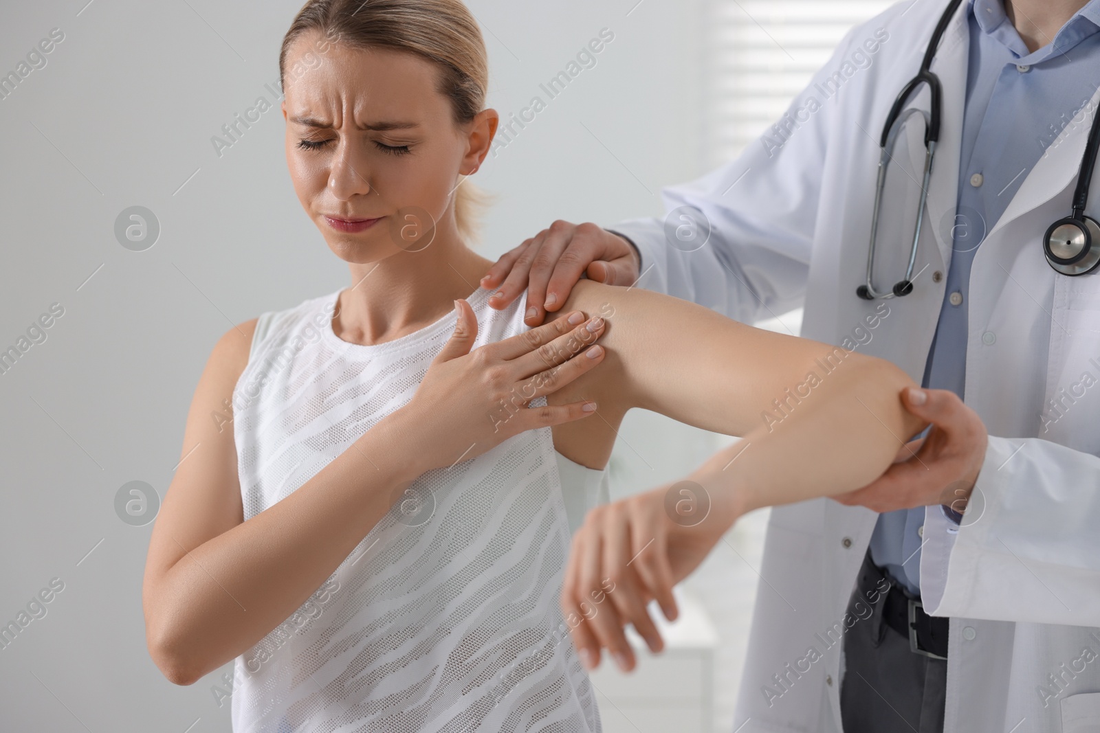 Photo of Sports injury. Doctor examining patient in hospital, closeup