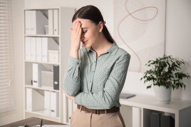 Photo of Portrait of embarrassed young woman in office