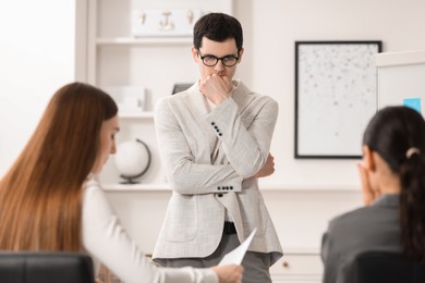 Photo of Man feeling embarrassed during business meeting in office