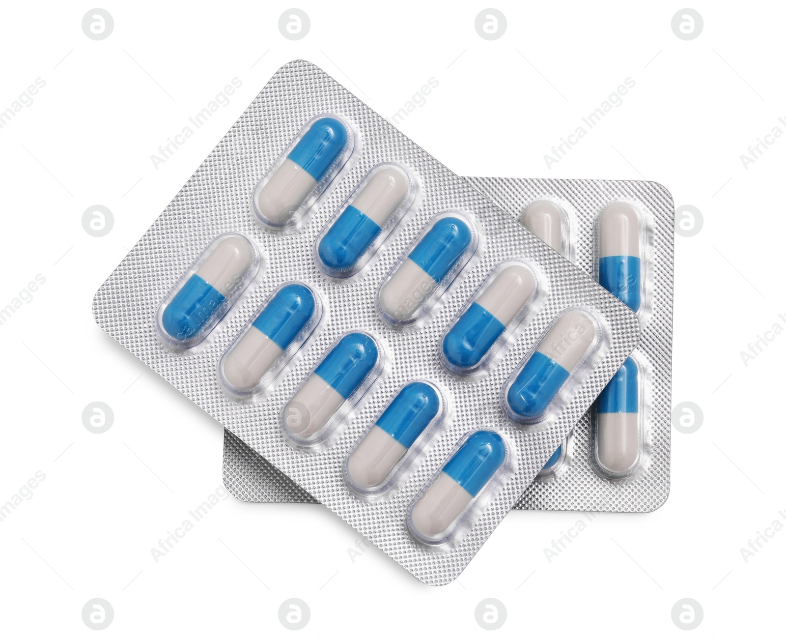 Photo of Antibiotic pills in blisters isolated on white, top view