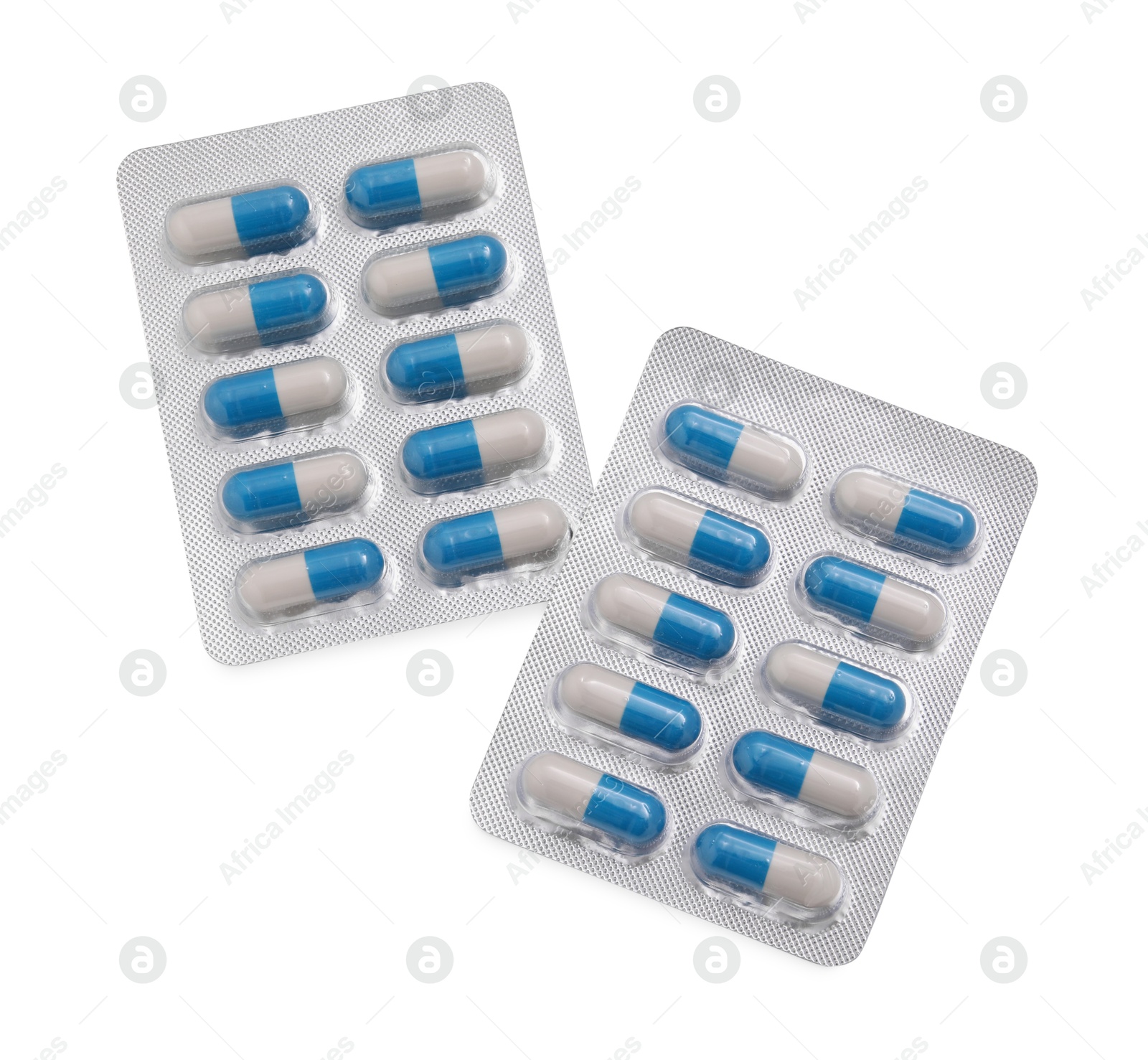 Photo of Antibiotic pills in blisters isolated on white, top view