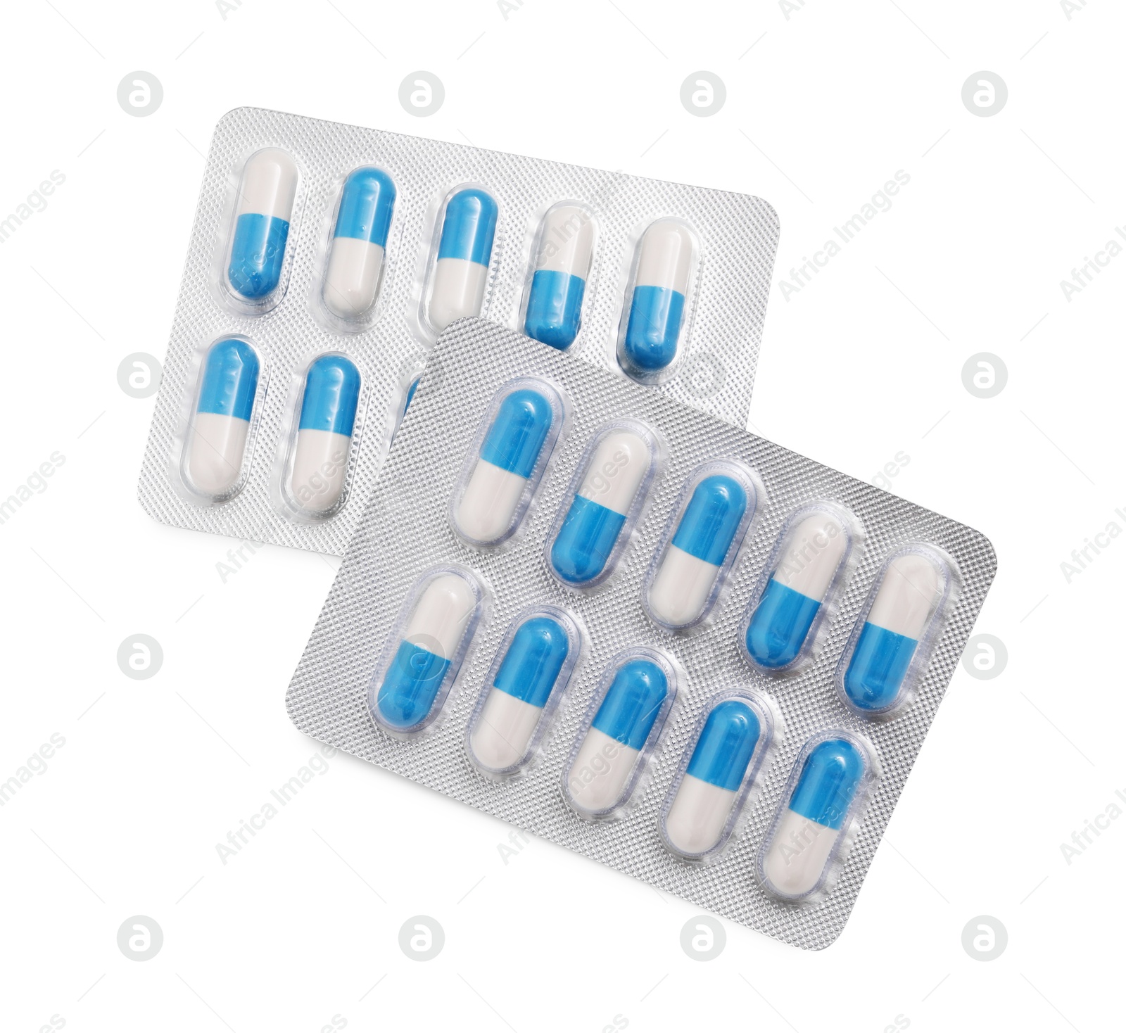 Photo of Antibiotic pills in blisters isolated on white, top view