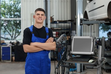 Young auto mechanic at automobile repair shop