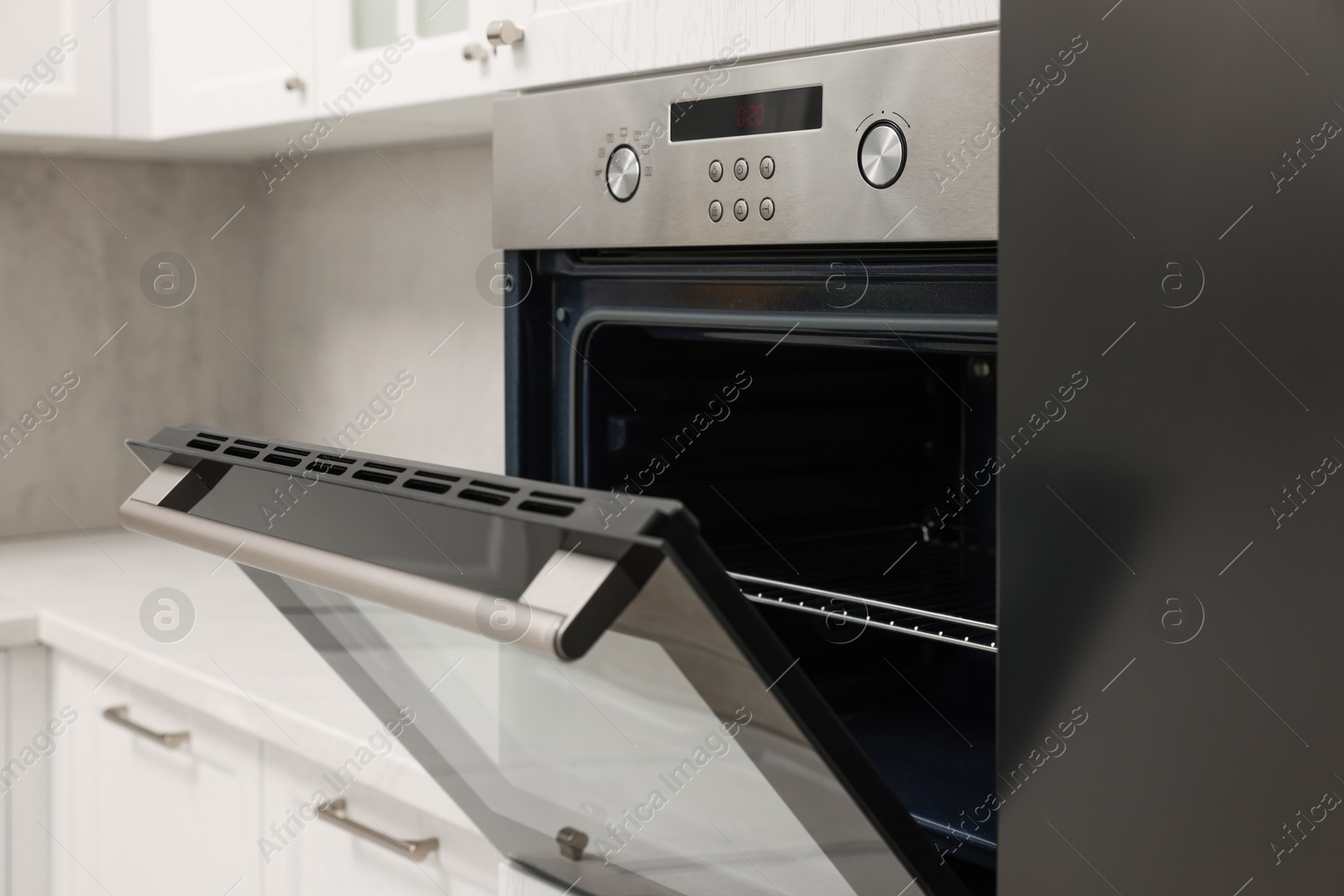 Photo of Open electric oven in kitchen. Cooking appliance