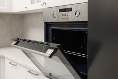 Photo of Open electric oven in kitchen. Cooking appliance