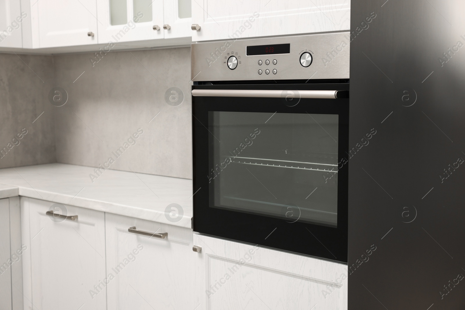 Photo of New electric oven in kitchen. Cooking appliance