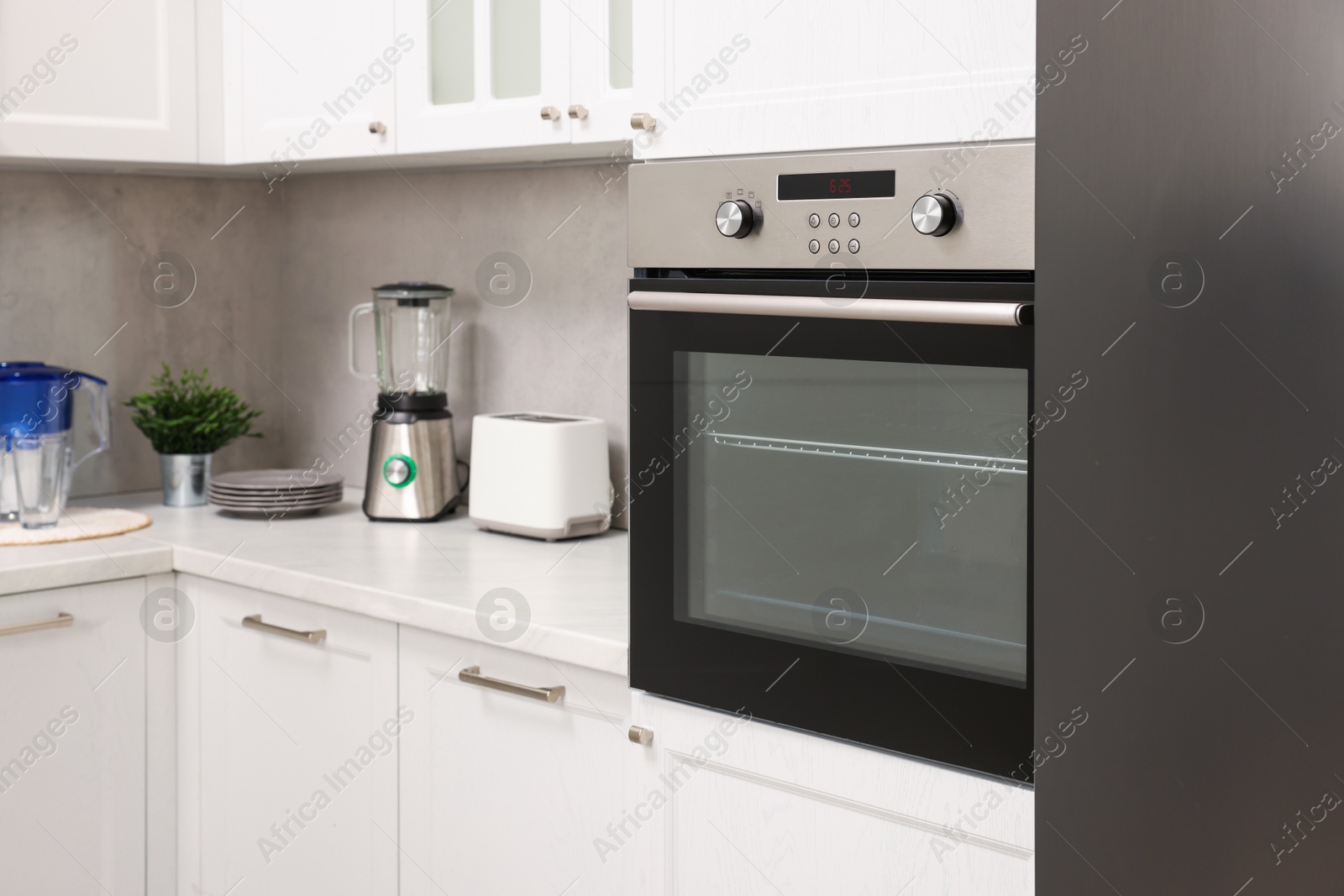 Photo of New electric oven in kitchen. Cooking appliance