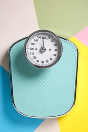 Photo of One bathroom scale on color background, top view