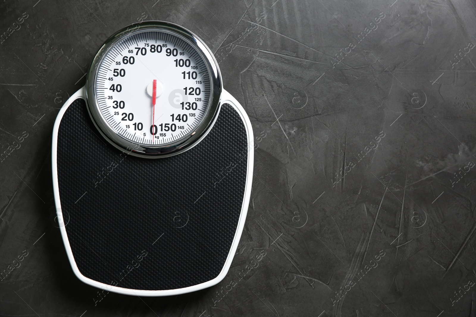 Photo of One bathroom scale on grey textured background, top view. Space for text