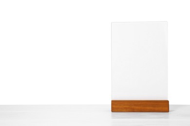 Photo of Menu holder on light wooden table against white background. Space for text