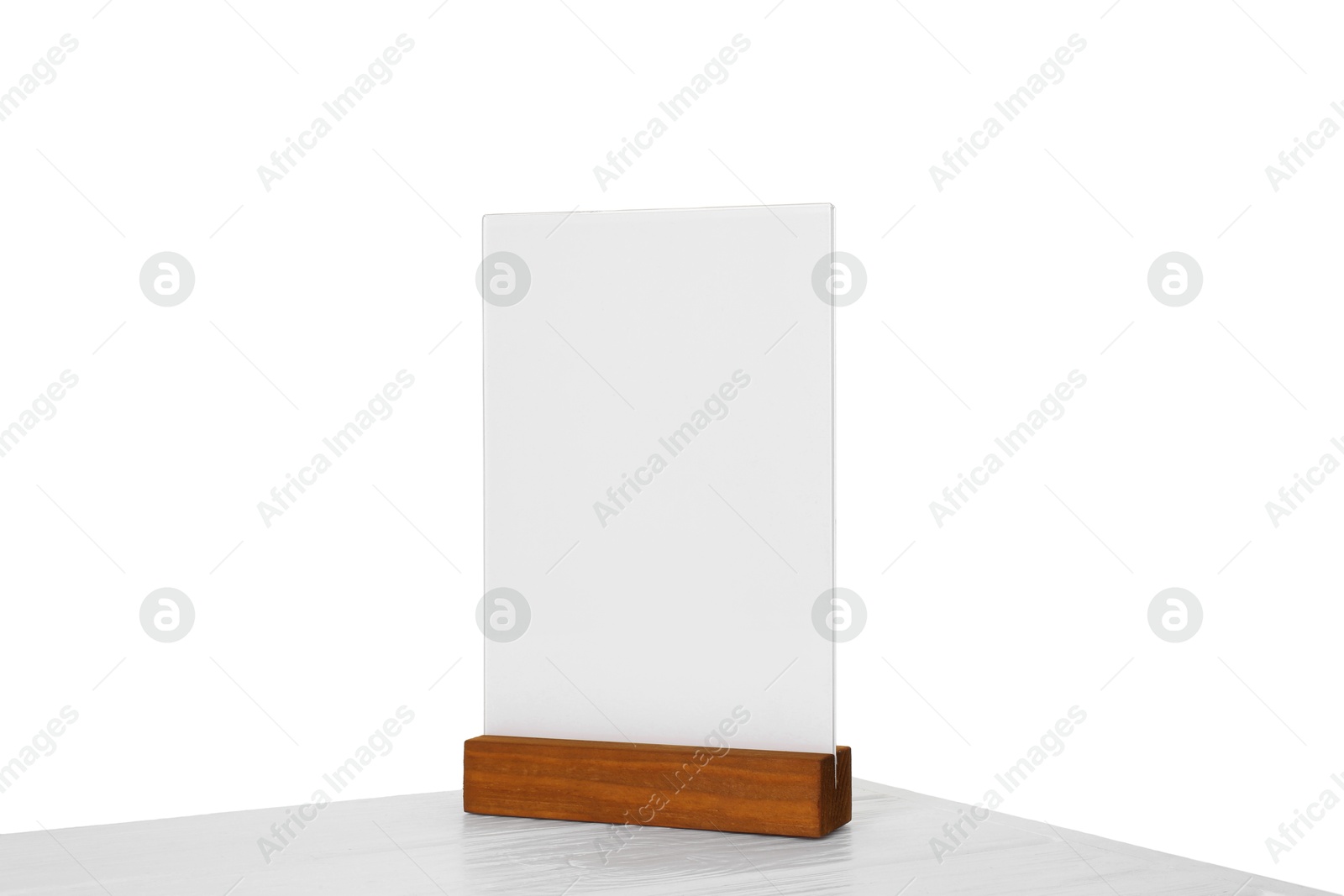 Photo of Menu holder on light wooden table against white background. Mockup for design