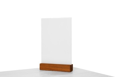 Photo of Menu holder on light wooden table against white background. Mockup for design