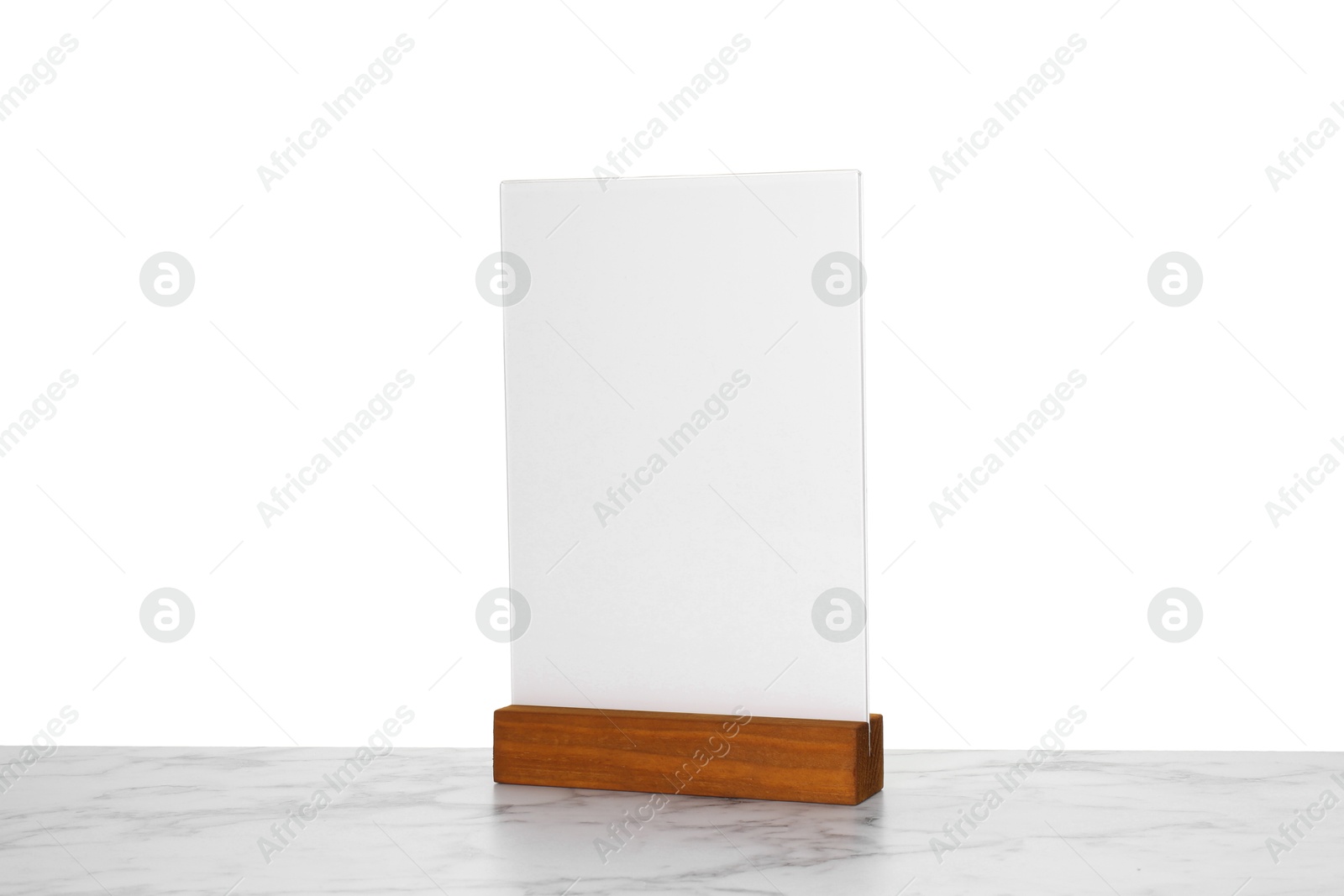 Photo of Menu holder on light marble table against white background. Mockup for design