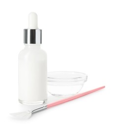 Photo of Bottle of chemical peel, bowl with liquid and brush isolated on white. Peeling procedure