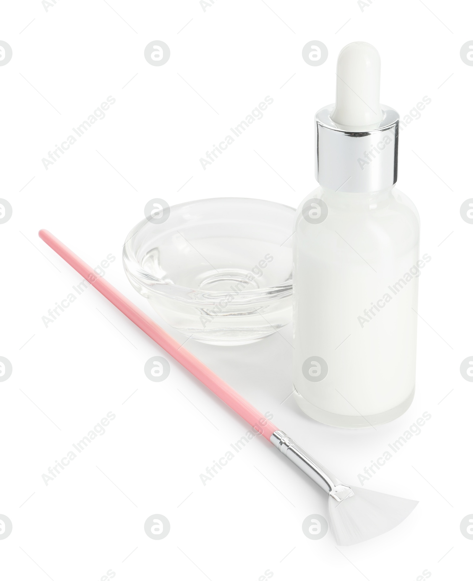 Photo of Bottle of chemical peel, bowl with liquid and brush isolated on white. Peeling procedure