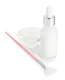 Bottle of chemical peel, bowl with liquid and brush isolated on white. Peeling procedure