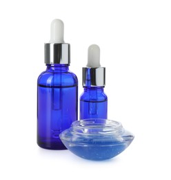 Photo of Bottles of chemical peel and bowl with liquid isolated on white. Peeling procedure