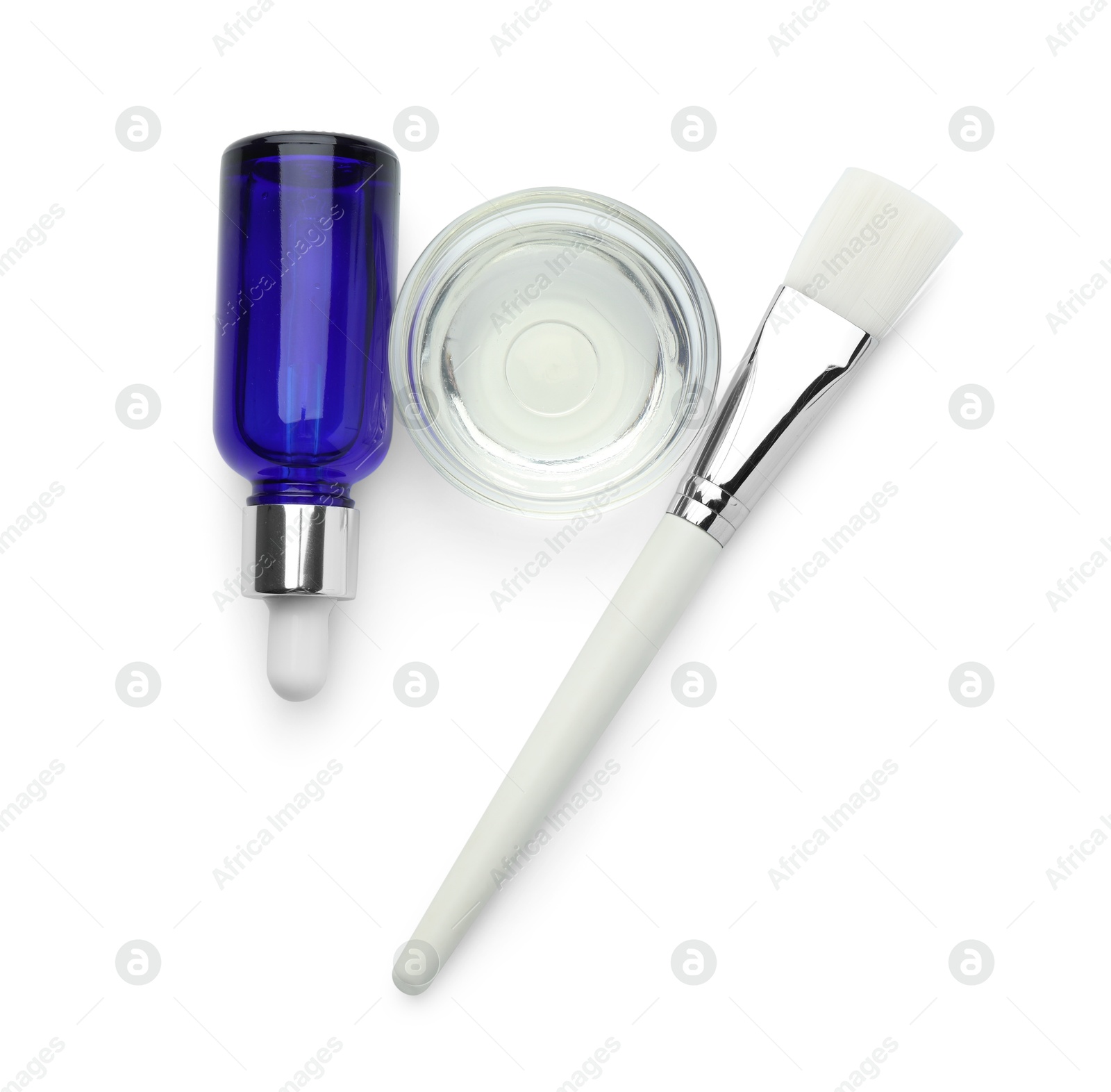 Photo of Bottle of chemical peel, bowl with liquid and brush isolated on white, top view. Peeling procedure