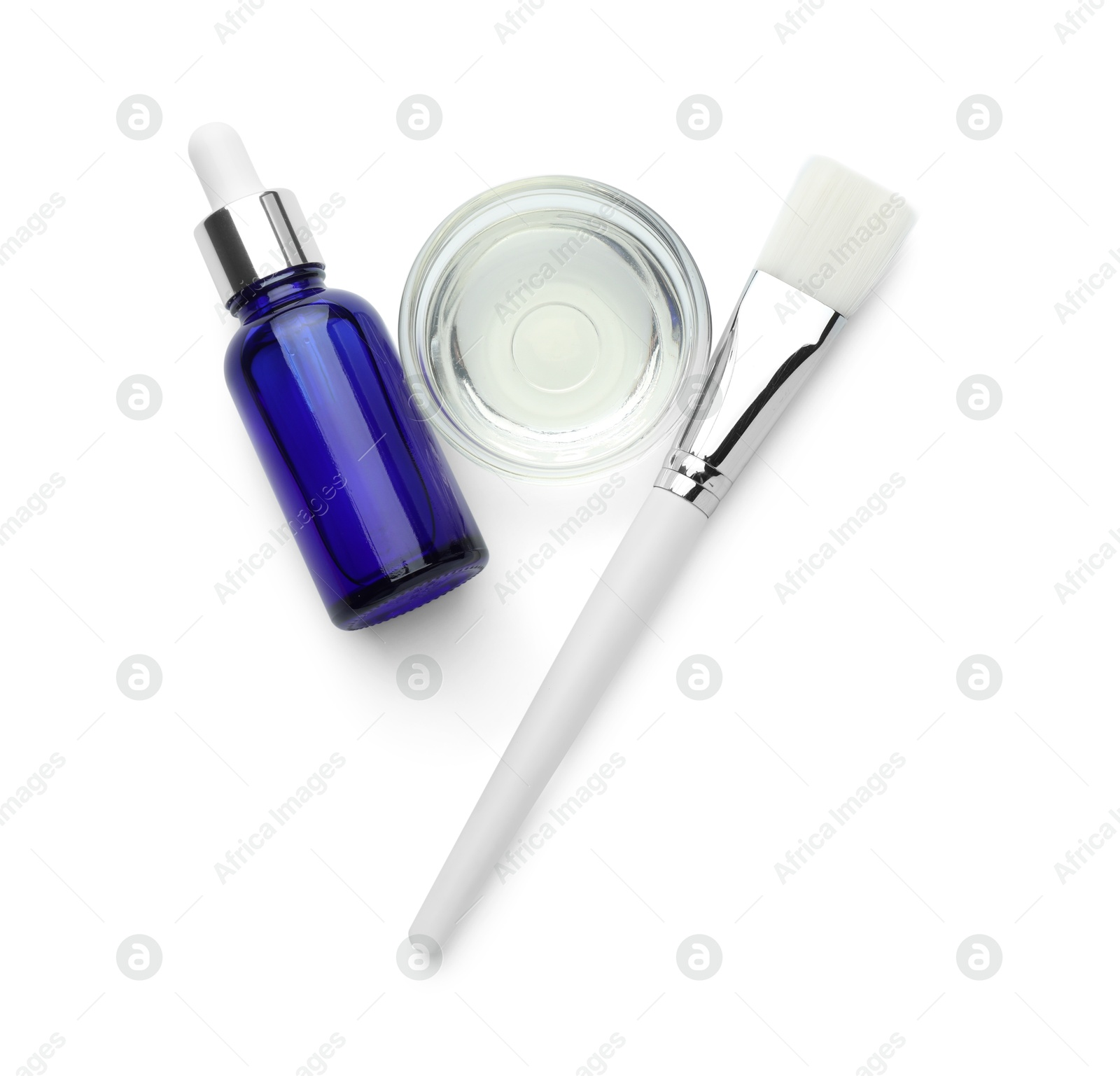 Photo of Bottle of chemical peel, bowl with liquid and brush isolated on white, top view. Peeling procedure