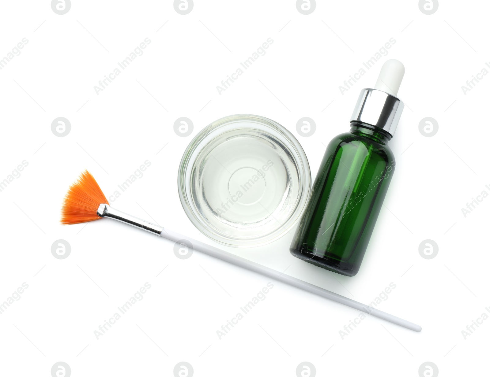 Photo of Bottle of chemical peel, bowl with liquid and brush isolated on white, top view. Peeling procedure