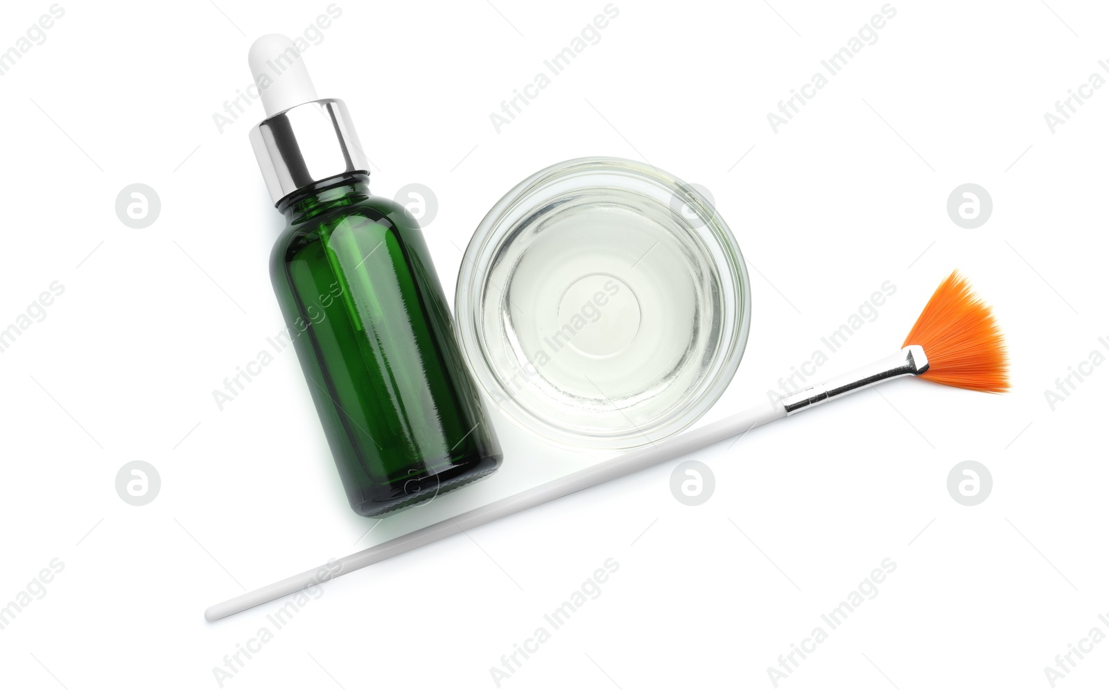 Photo of Bottle of chemical peel, bowl with liquid and brush isolated on white, top view. Peeling procedure