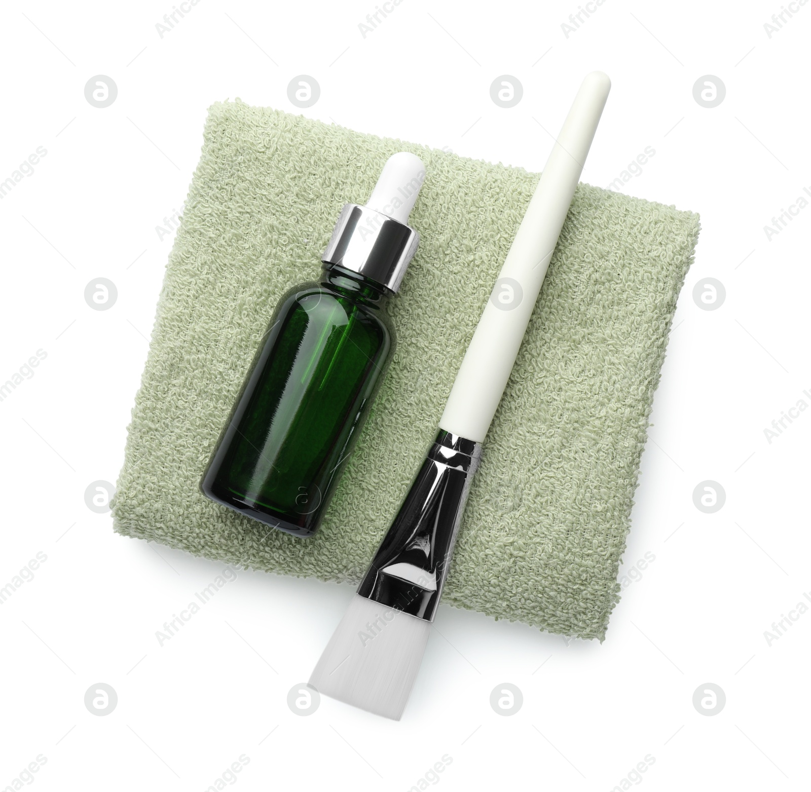 Photo of Bottle of chemical peel, brush and soft towel isolated on white, top view. Peeling procedure