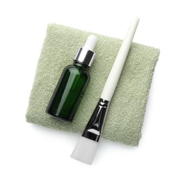 Photo of Bottle of chemical peel, brush and soft towel isolated on white, top view. Peeling procedure