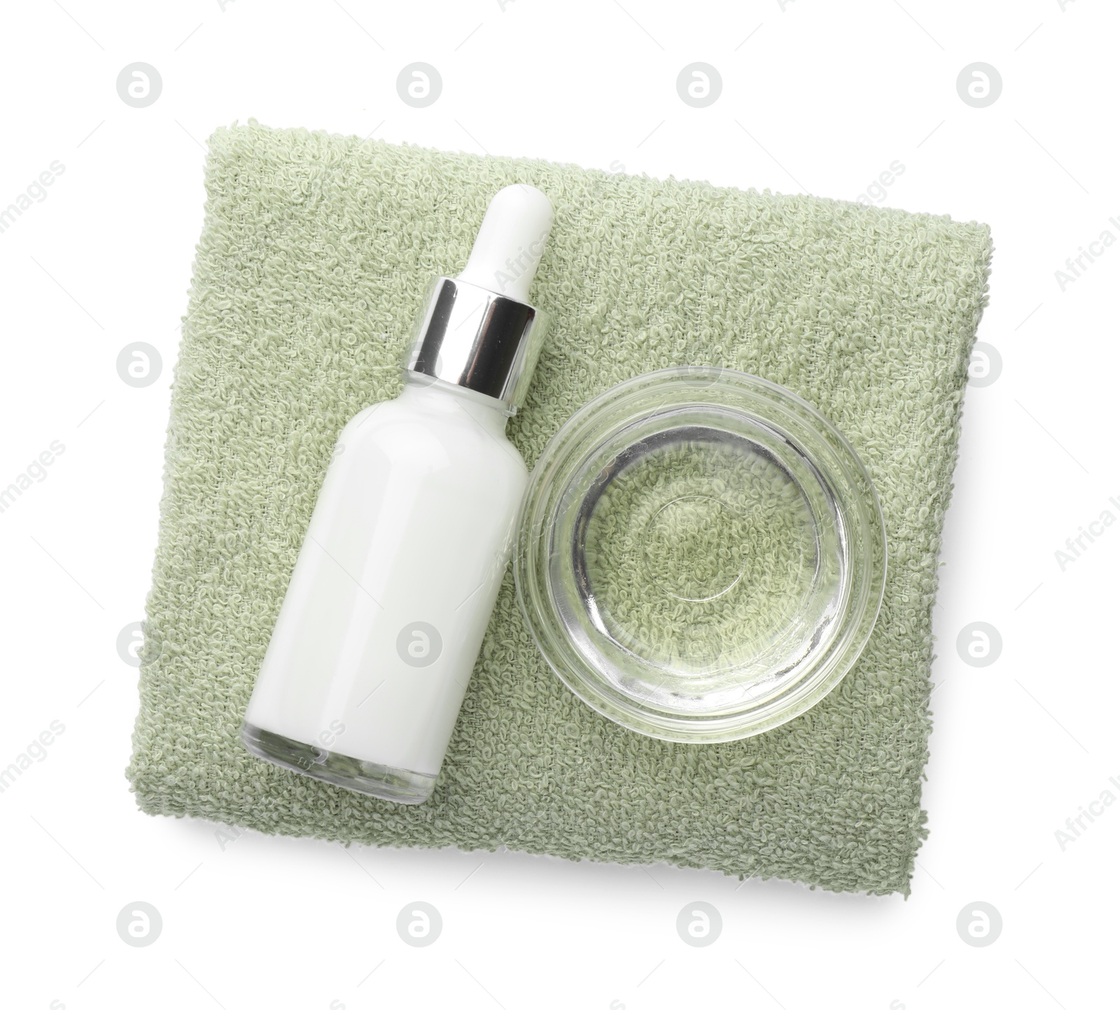 Photo of Bottle of chemical peel, bowl with liquid and soft towel isolated on white, top view. Peeling procedure