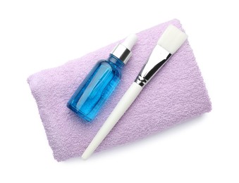 Photo of Bottle of chemical peel, towel and brush isolated on white, top view. Peeling procedure