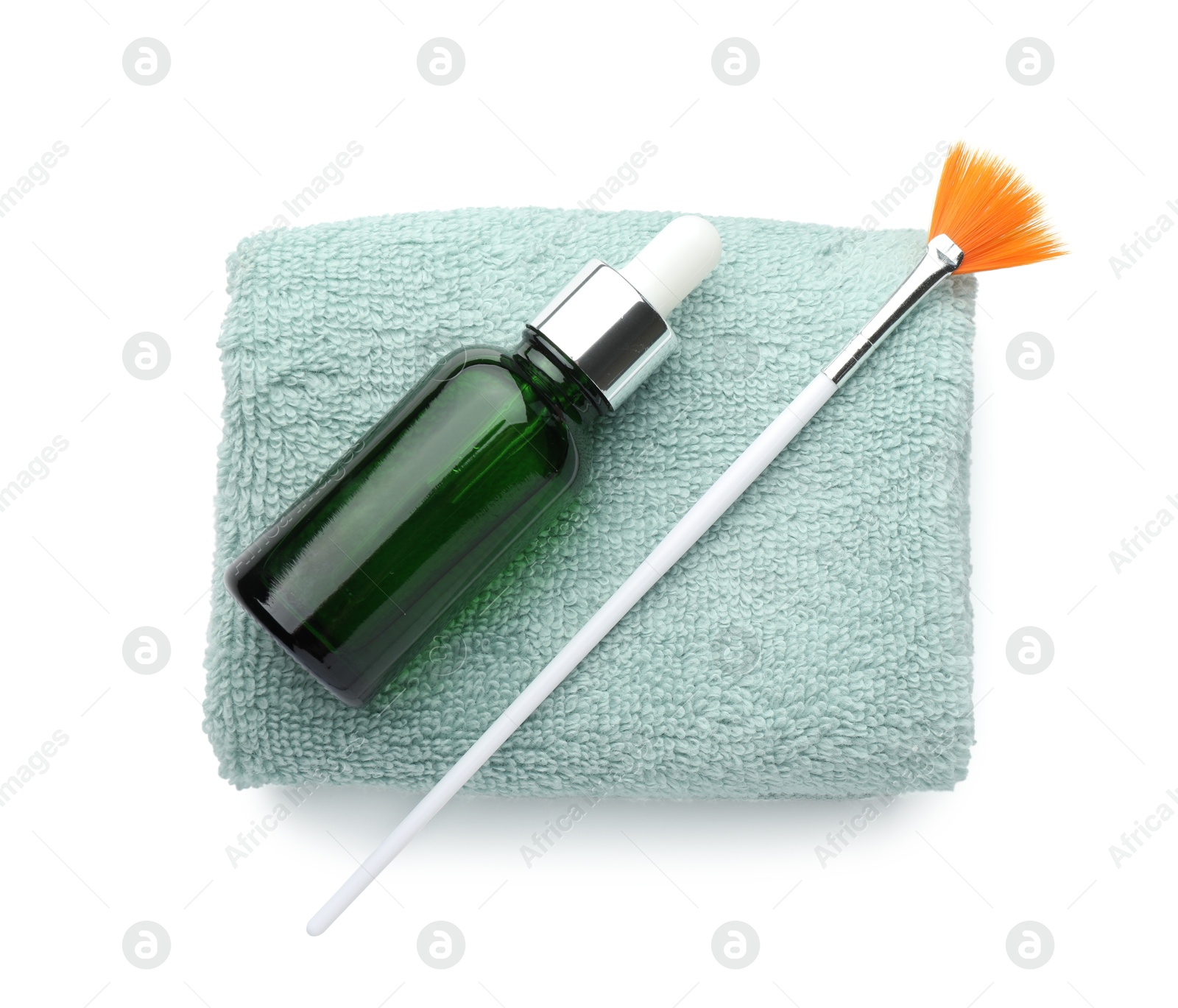 Photo of Bottle of chemical peel, towel and brush isolated on white, top view. Peeling procedure