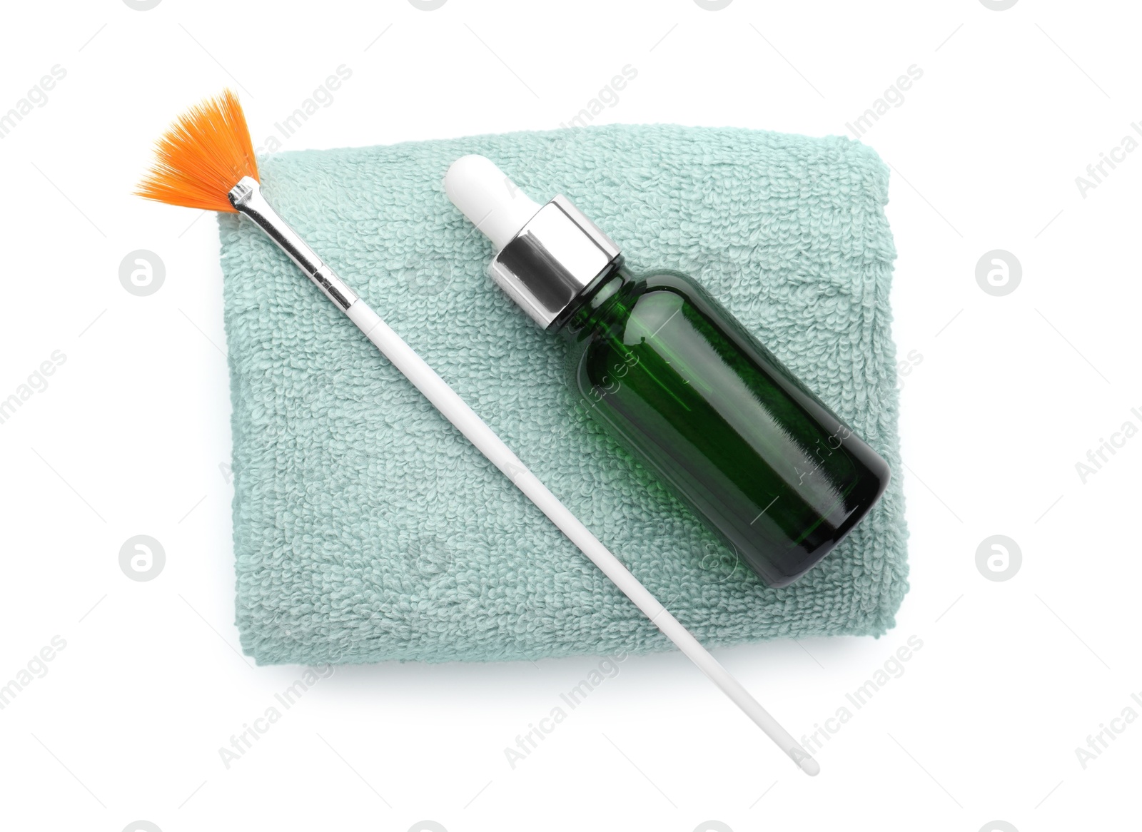 Photo of Bottle of chemical peel, towel and brush isolated on white, top view. Peeling procedure