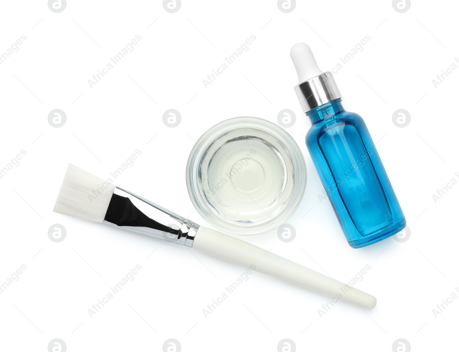 Photo of Bottle of chemical peel, bowl with liquid and brush isolated on white, top view. Peeling procedure